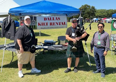 Dallas Kilt Rental tent at a Texas Highland festival with a piper in a kilt